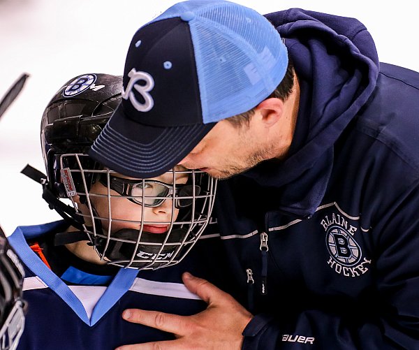 Coach with hockey player