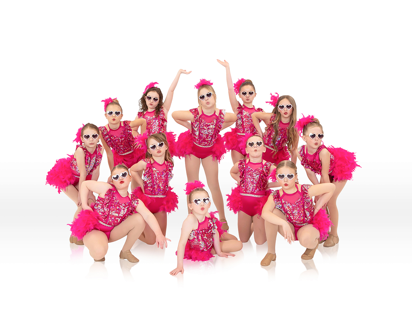 Little girls' team dance portrait wearing sunglasses, pink sparkly dance outfits.