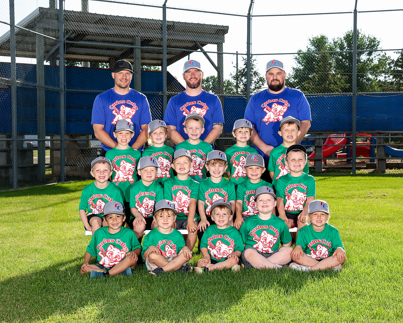 Little boys' baseball team photo outdoor portrait with coaches.