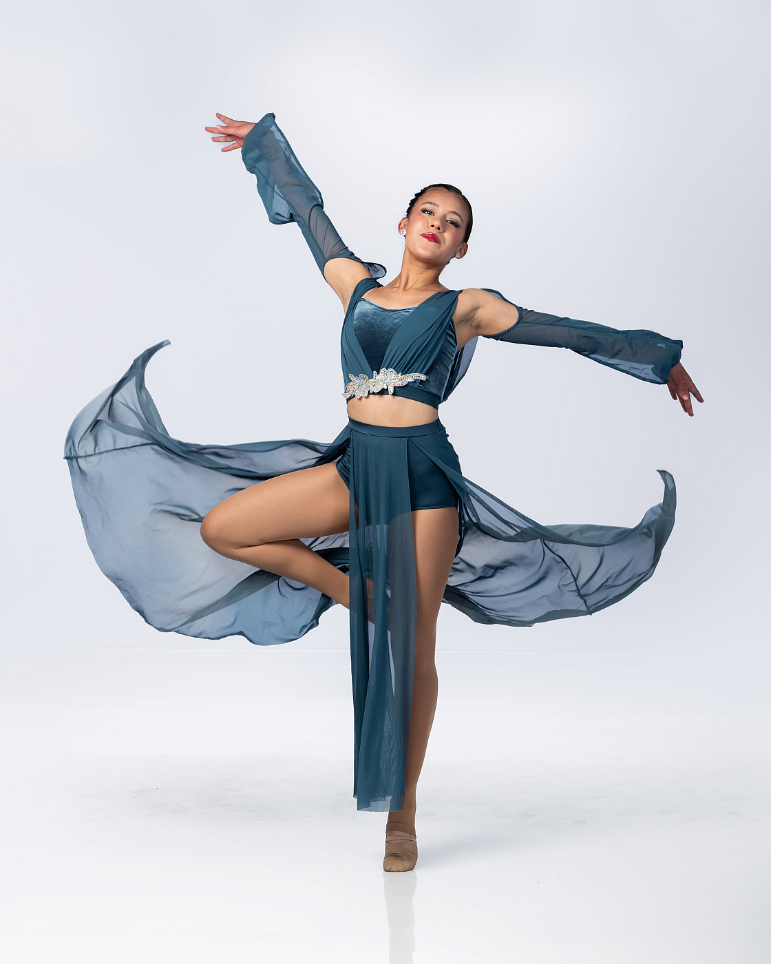 Girls dance portrait in teal dance outfit indoor white background.