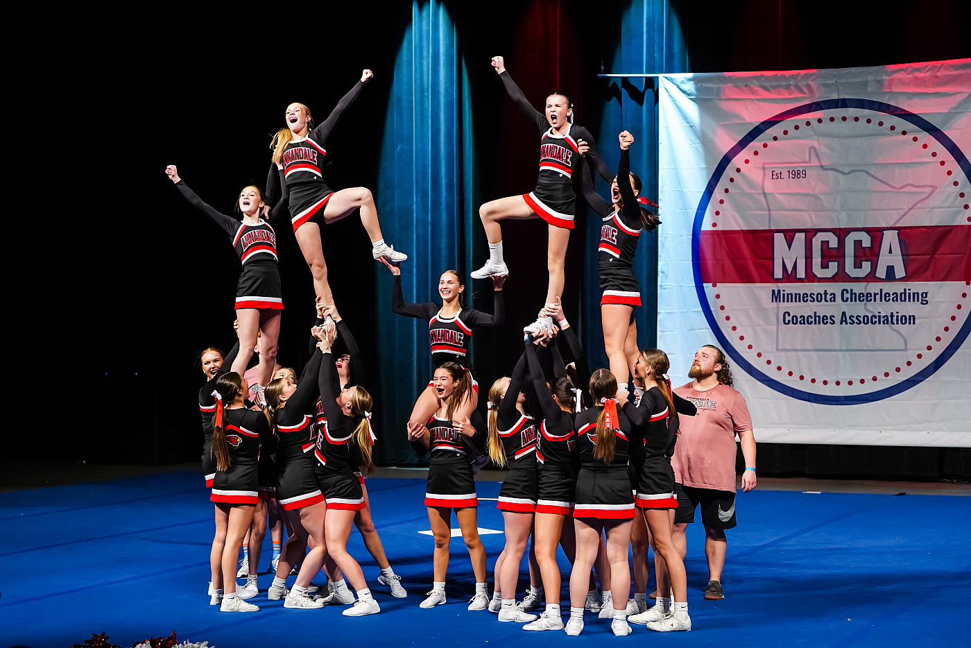 minnesota cheerleading competition photo of team lifts annandale black and red uniforms