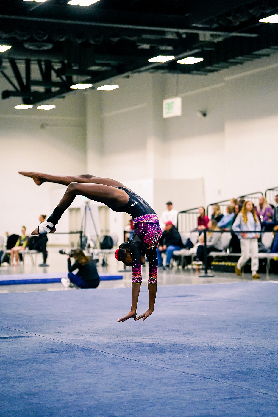gymnast flipping on floor during gymnastics competition 