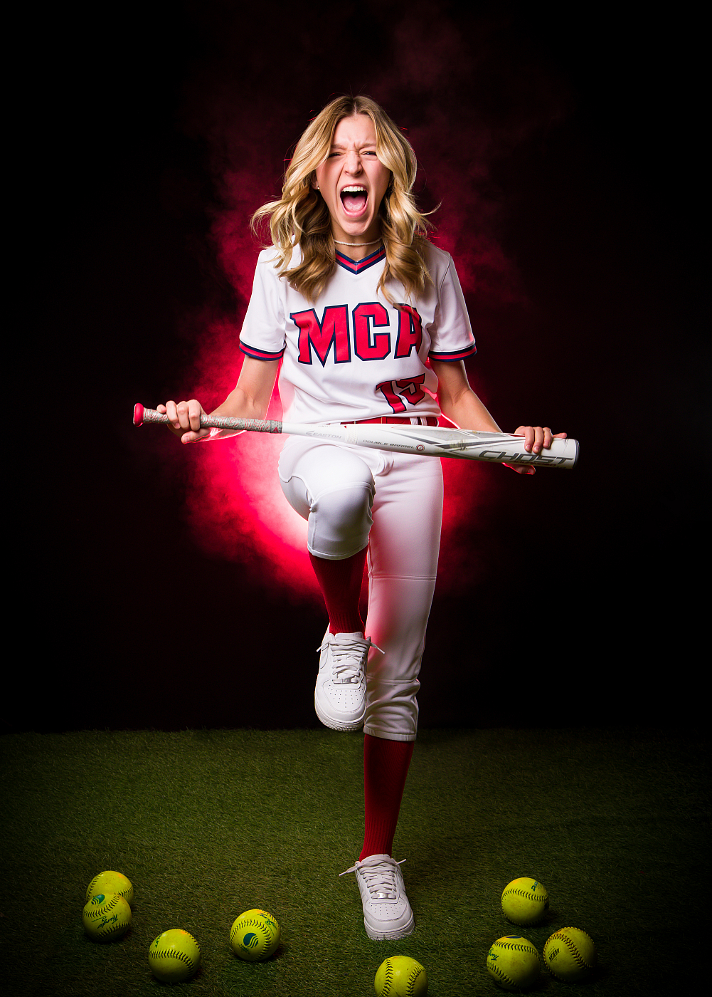 emotive softball player pretending to break bat over leg 