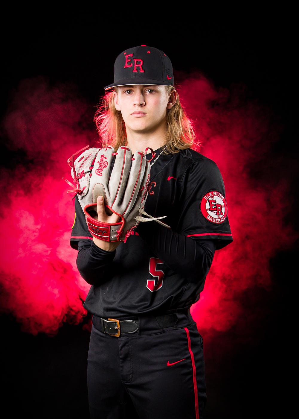 high school baseball portrait with red smoke background