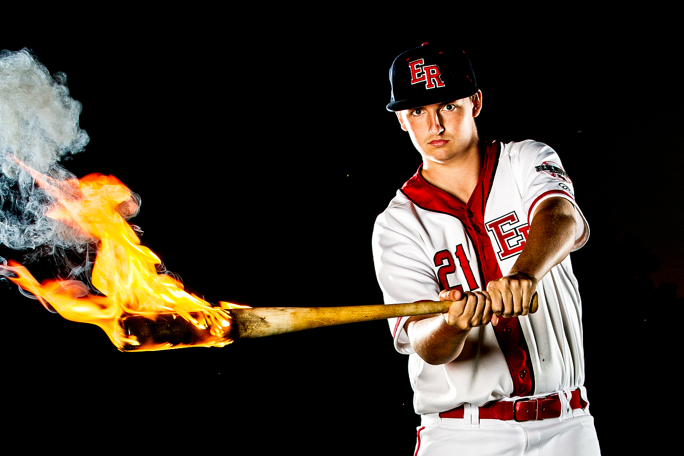 elk river baseball player swining bat in flames
