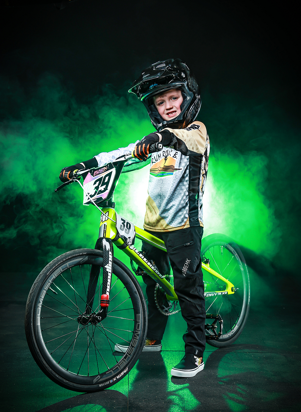 boy posing with bmx bike green smoke in background